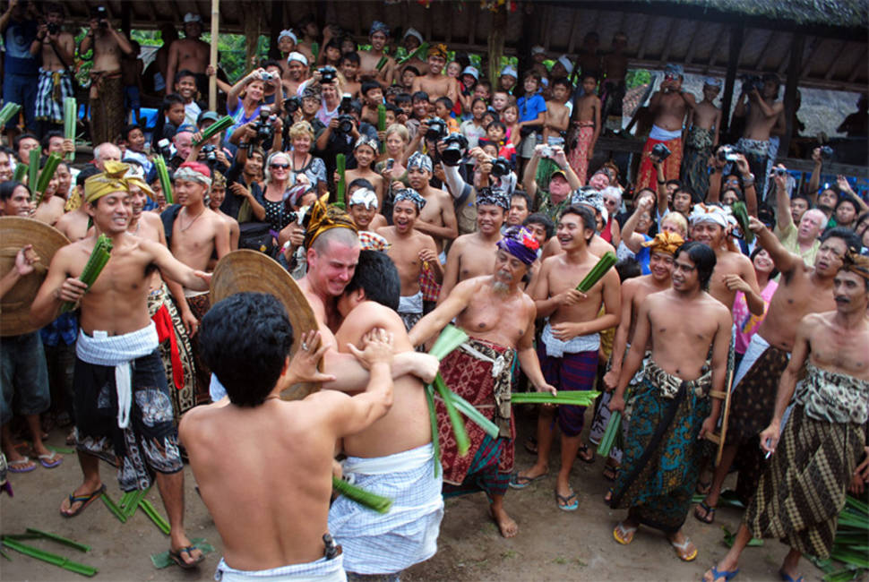 A tourist participating a traditional battle with local man in Makare-Kare