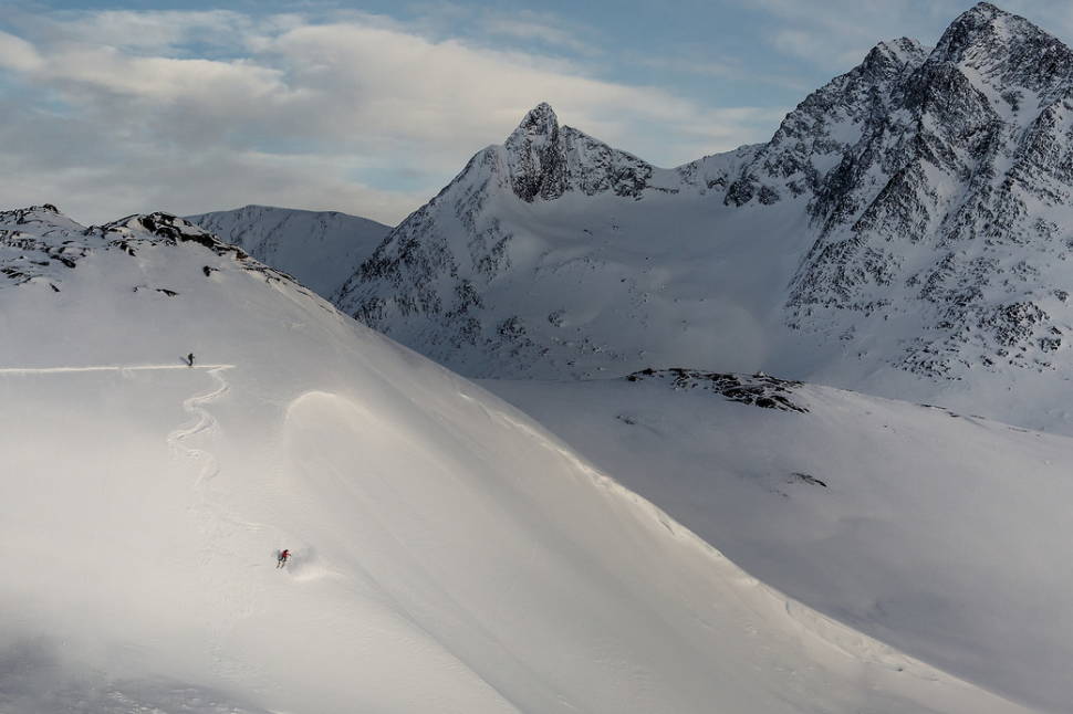A skier carving a steep line near Kuummiut in East Greenland