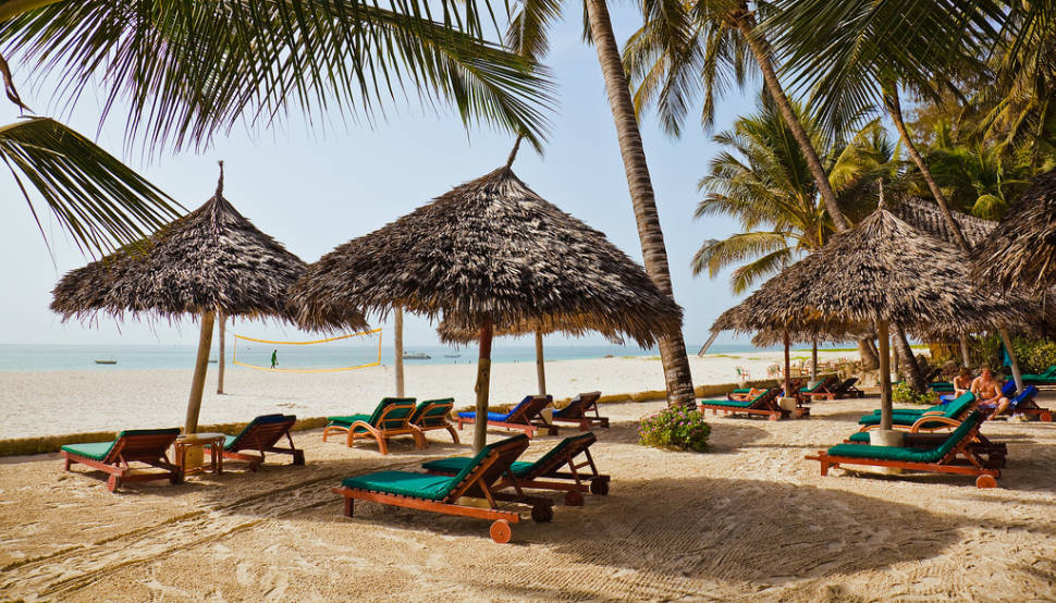 Shaded loungers under the palm trees, facing the Indian Ocean. Pinewood Beach Resort, Mombasa.