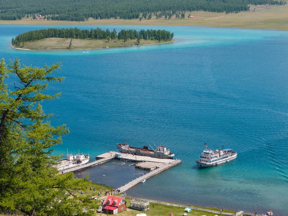 The ferry 'Sukhbaatar' on a tourist run on Lake Khovsgol arrives at the wharf at Hatgal