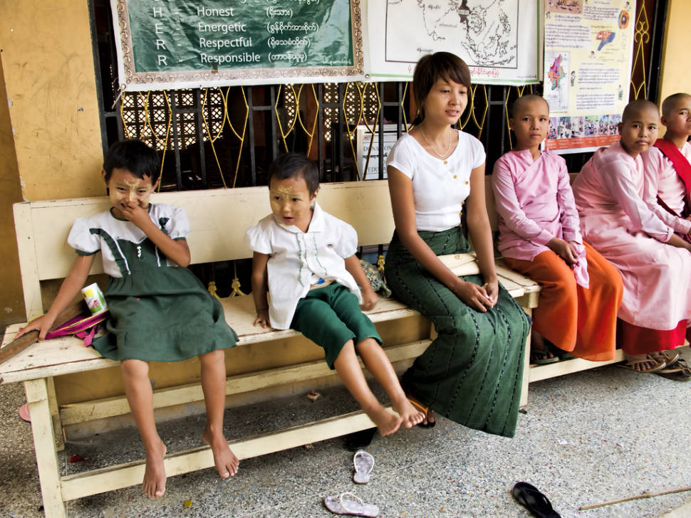 A teacher and some students including novice Buddhist nuns at Aung Myae OO Monastic Education School on Sagaing Hill across the Irrawaddy River from Mandalay