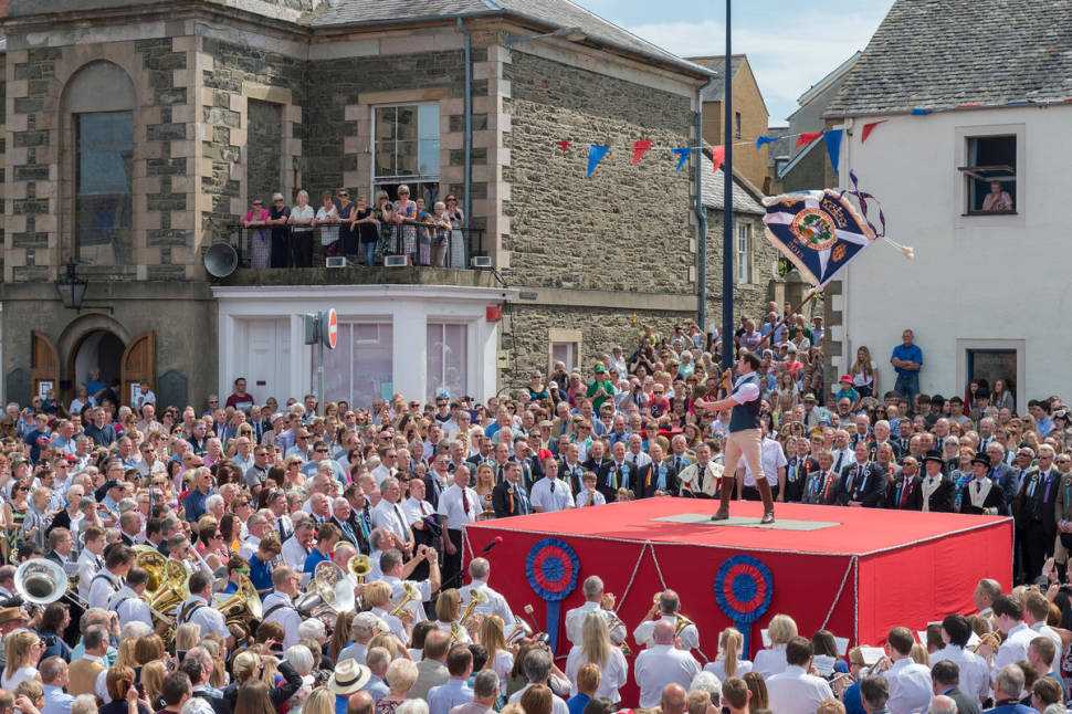 Selkirk Common Riding. Standard Bearer Scott Rodgerson casts the Burgh flag at the Casting Of The Colours ceremony