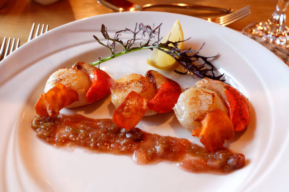 A starter of pan-seared Orkney scallops, served with pickled rhubarb and sweet potato crisps