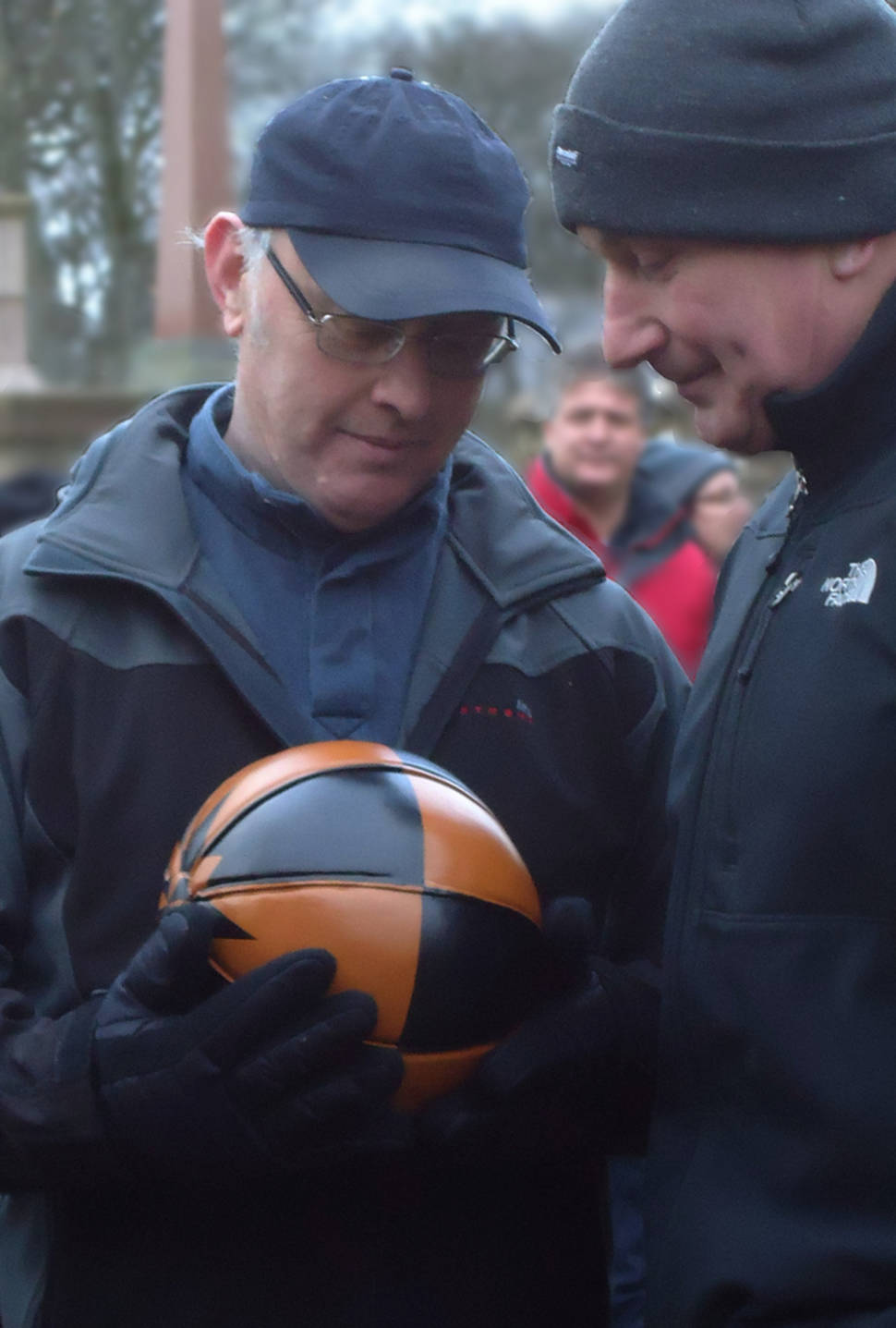 Inspecting the Ba'. The Ba' is nursed lovingly just a few minutes before being tossed to the awaiting teams