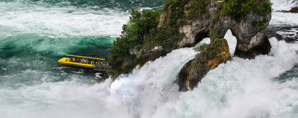 Taking boat to the rock in the middle of the falls