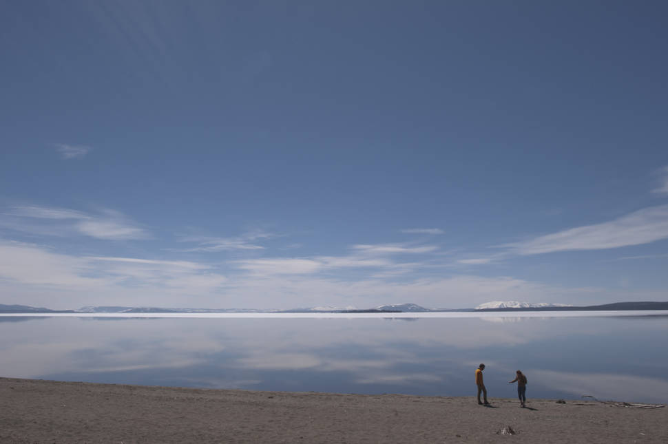 Visitors standing on the shore of Yellowstone Lake (outside the Fishing Bridge Visitor Center)